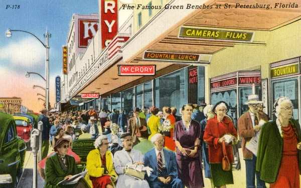 Vintage color postcard of the famous green benches lining a busy downtown St. Petersburg street