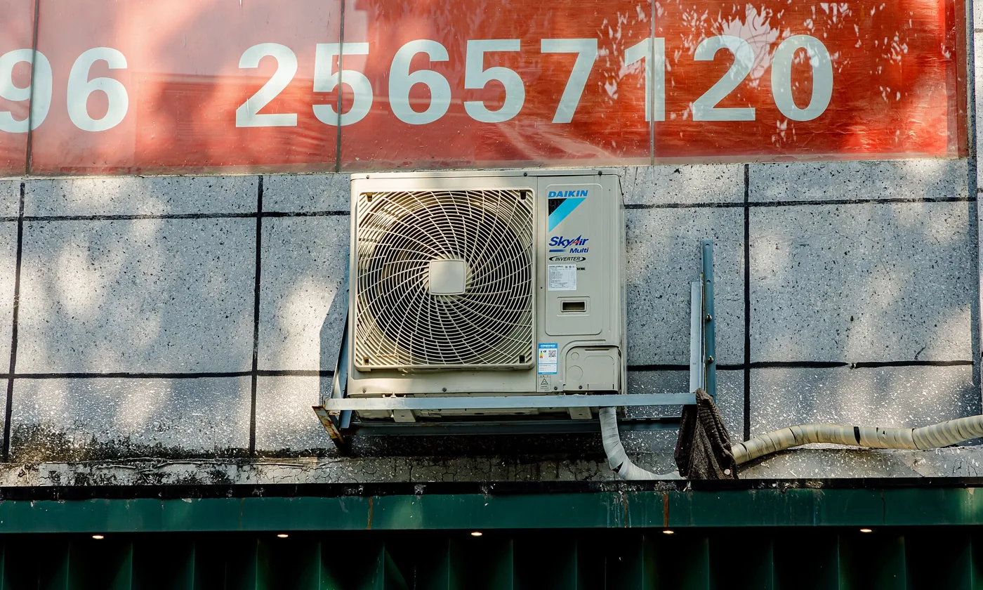 An outdoor AC unit mounted beside a building