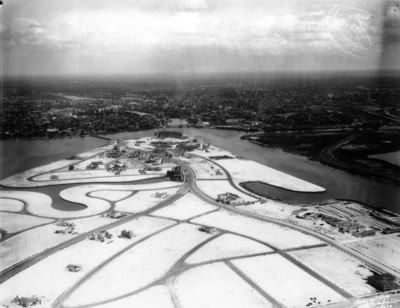 A 1927 aerial view of Davis Islands partly built up with new streets and lots, water all around and downtown Tampa in the distance.