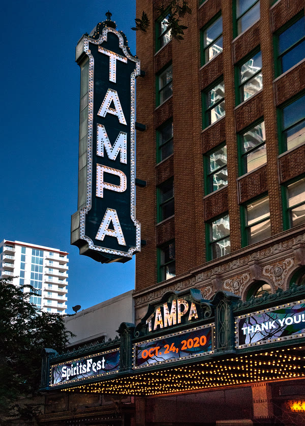 The tall vertical neon 'TAMPA' sign on the front of the historic Tampa Theatre, present day.
