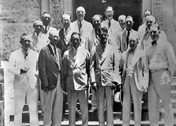 A group of men in suits posed in two rows for a formal outdoor portrait — the members of Florida's first Citrus Commission.